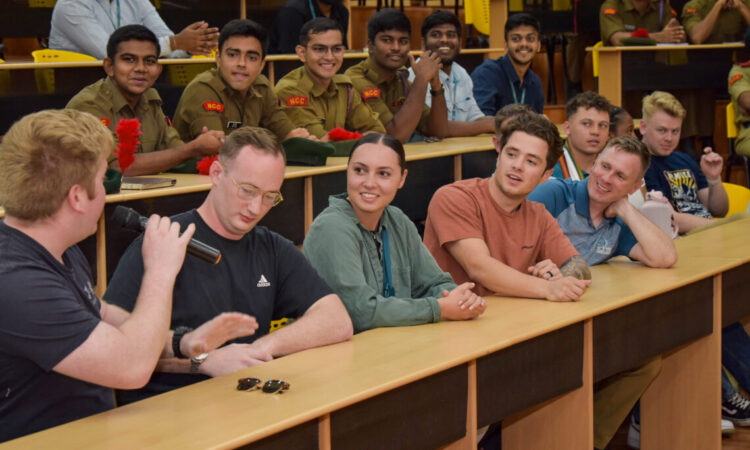 Student with microphone, more students listening, military members